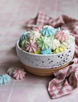 Small colorful meringues in the  ceramic bowl