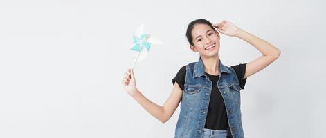 Teenage woman and paper windmill toys. teen with wind wheel stick photo