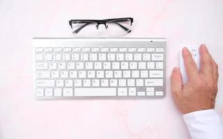 Businessman working on computer in office, closed up typing keyboard photo