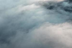 Morning fog in the mountains from above photo