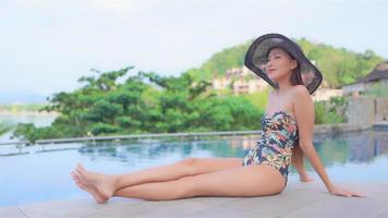 jonge aziatische vrouw geniet van buitenzwembad video