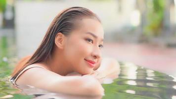 Young Asian Woman Enjoys Outdoor Swimming Pool video