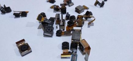 A pile of broken cellphone cameras photo