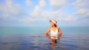 Young woman enjoys around outdoor swimming pool video