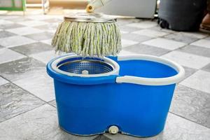 Close-up of mops and a bucket of products for cleaning floors. photo