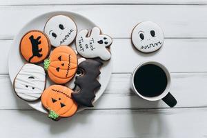 Preparation for Halloween. Coffee and scary gingerbread cookies. photo