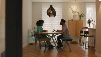 Woman and man sitting at table having vivid conversation video