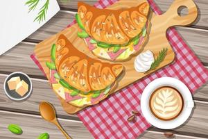 Breakfast croissant sandwich with a cup of lemon tea on the table vector