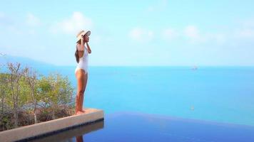 Young woman enjoys around outdoor swimming pool video