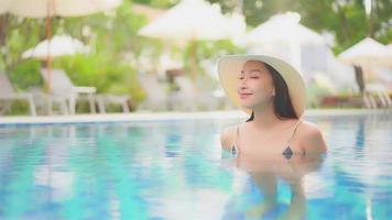 Young woman enjoys around outdoor swimming pool video