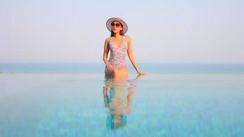 Young woman enjoys around outdoor swimming pool video