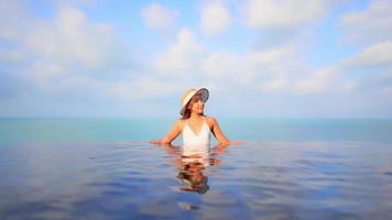 Young woman enjoys around outdoor swimming pool video