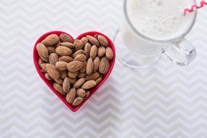 Heart Shaped Bowl of Almonds and Almond Milk photo