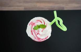 strawberry smoothie on white bricks background. photo