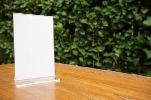 Mock up Menu frame standing on wood table in Bar photo