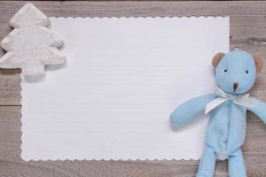 Wooden table white letter paper blue bear doll Christmas tree craft photo