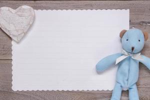 Wooden plank table white letter paper blue bear doll heart craft photo