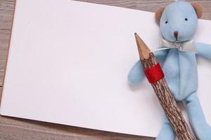 Wooden pencil blank sketch white paper blue bear doll photo