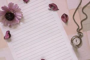 Paper with flowers and a pocket watch photo