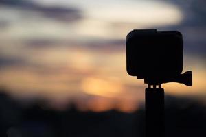 Silhouette Action camera in front of the twilight sky photo