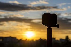 Silhouette Action camera in front of the twilight sky photo