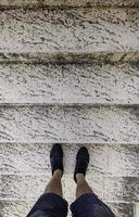 Man's feet on ladder photo