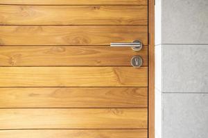 Stainless steel door handle and wooden door photo