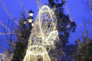 White glowing lights garlands in the shape of a horse's head of Russian Troika on the street photo