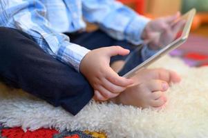 Kid holding tablet photo