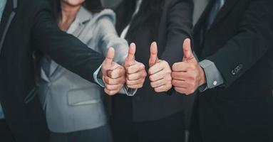 Business People Teams Giving Thumbs up While Standing in Office photo