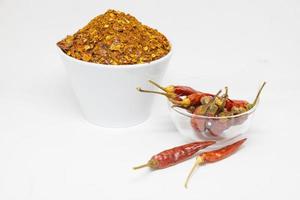 dried red chillies in a white cup on a white background photo