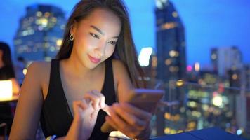 ung asiatisk kvinna som använder en smartphone video