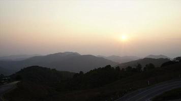 timelapse sunset with mountain layer and beautiful road in Thailand video