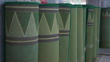 Rolled stack carpets in front of a mosque, Indonesia photo