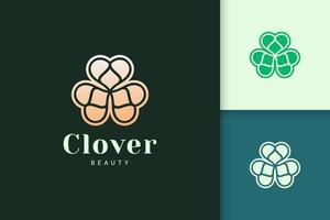 Clover leaf logo in luxury gold color represent lucky or herb vector