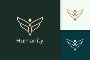 Logotipo de libertad de lujo en humanos y alas que representan la humanidad o la paz. vector