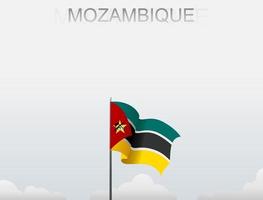 Flag of Mozambique flying under the white sky vector