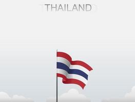 Flag of Thailand flying under the white sky