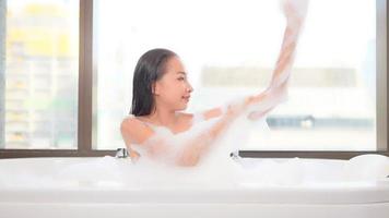 Young asian woman taking a bath video