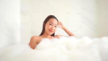 Young asian woman taking a bath