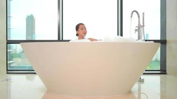 Young asian woman taking a bath video