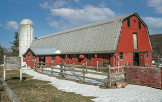 Red barn with a white silo photo