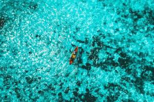 Aerial view of tourists paddle kayak in boulder island photo