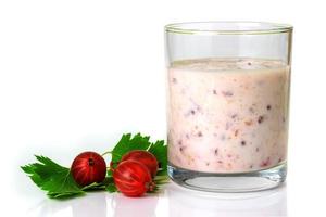 Smoothies with a red gooseberry berry on a white background photo