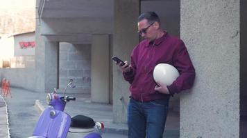Young stylish male with colorful motor scooter video