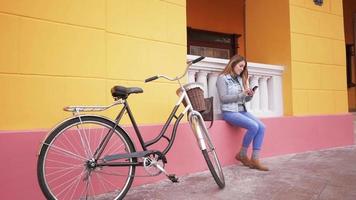Young woman with retro bicycle outdoors video