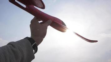 Male boy play with toy airplane in summer fields video