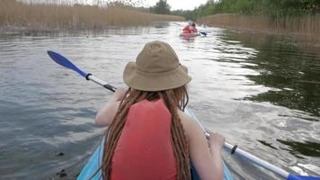 Young woman paddling a kayak