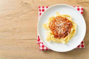 Pork bolognese fettuccine pasta with parmesan cheese photo