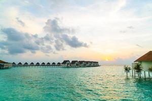 Beautiful tropical Maldives resort hotel and island with beach and sea photo